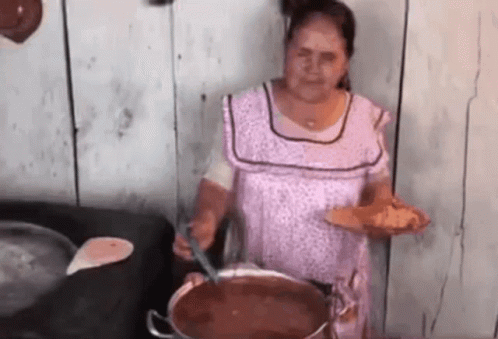 Woman Cooking and Serving Food